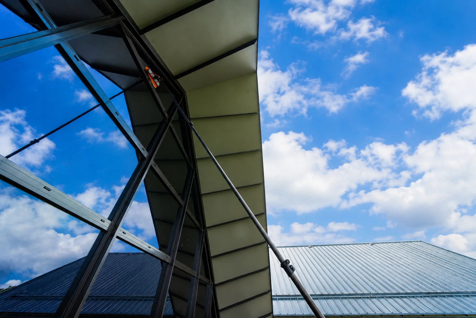 Reflective glazing beneath an angled roof